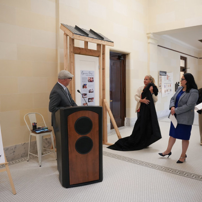 Image of people unveiling a framed door display.